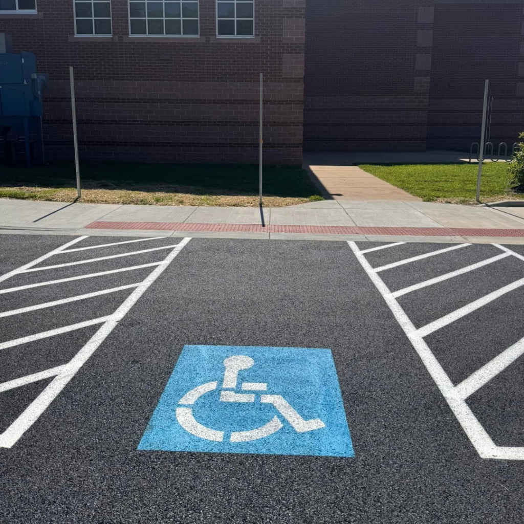 "Freshly marked parking lot with crosswalks, fire lanes, and directional arrows by Striping Bros.