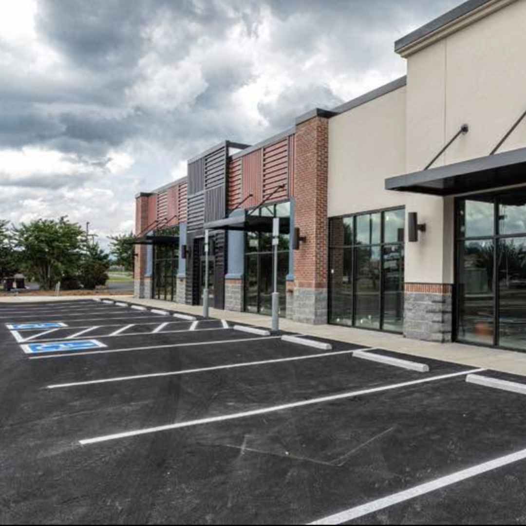 a parking lot with a building in the background