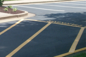 Directional arrows and crosswalk markings in a Biloxi parking lot.